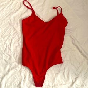 Red bodysuit, never worn, Great condition.